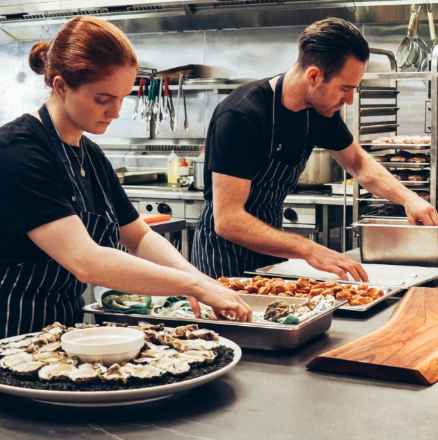 2 Chefs in the hospitality industry preparing food in the kitchen